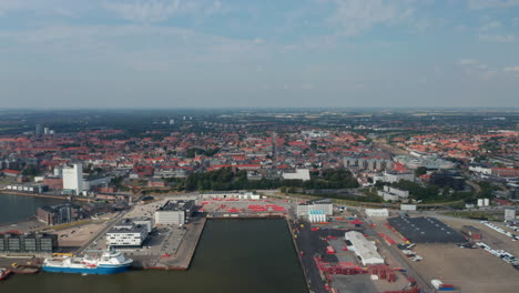 Flight-forward-over-the-seaport-of-Esbjerg,-the-most-important-of-Denmark-and-North-Sea.-Aerial-view-showing-a-beautiful-panorama-of-the-city-build-with-characteristic-red-brick