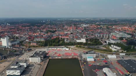 Drone-view-of-the-seaport-of-Esbjerg,-Denmark,-the-second-largest-harbor-in-North-Sea.-Stunning-birds-eye-aerial-view-of-the-skyline-of-the-city-moving-towards-harbor