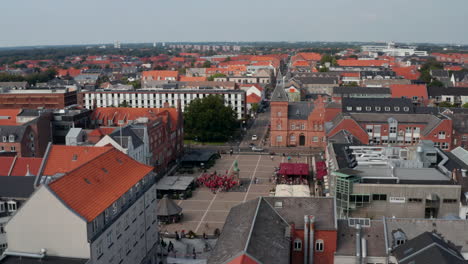 Aerial-Dolly-over-the-famous-Torvet-square-in-Esbjerg,-Denmark-with-town-hall-and-the-statue-of-Christian-IX.-Drown-view-showing-Torvegade-street,-one-of-the-longest-pedestrians-streets-in-Denmark