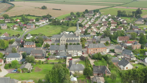 French-Suburban-Area-Rural-Small-Town-with-Church-in-the-center,-Aerial-Circling-View