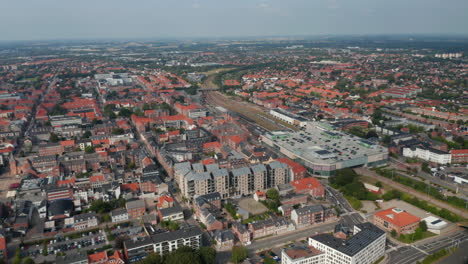 Aerial-stunning-view-of-Esbjerg,-Denmark.-Panning-drone-view-over-the-characteristic-brick-buildings-of-one-of-the-most-important-North-Sea-seaport