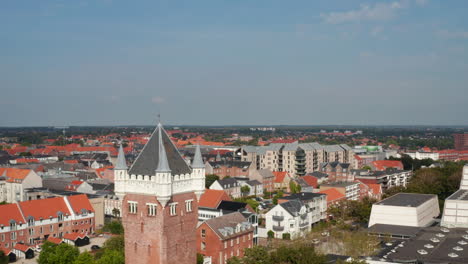 Aerial-vertical-view-of-Esbjerg,-Denmark.-Landing-drone-view-revealing-the-Water-Tower,-a-danish-landmark-at-the-top-of-a-cliff