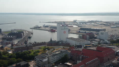 Aerial-view-of-Esbjerg-harbor,-the-primary-port-for-oil-and-gas-sector-and-leading-for-offshore-wind-in-Europe.-High-angle-view-of-Valsemollen,-a-corporation-producing-grain-and-flour-products