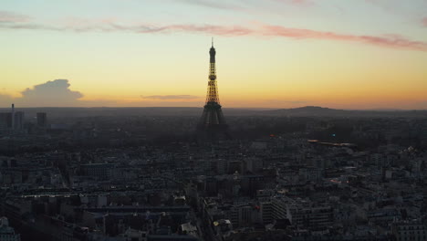 Aerial-panoramic-shot-of-metropolis.-Silhouette-of-Eiffel-Tower-against-colourful-twilight-sky.-Paris,-France