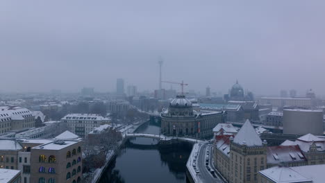 Aerial-view-of-historic-buildings-of-Bode-Museum.-Reveal-winter-city-around-Spree-river.-Hazy-view-of-Berliner-dom-and-Fernsehturm.-Berlin,-Germany