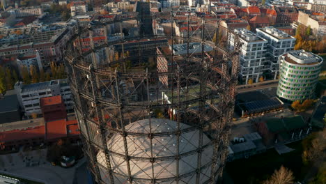 Big-Metal-structure-Gasometer-in-Berlin,-Germany,-Aerial-tilt-down-high-angle-view