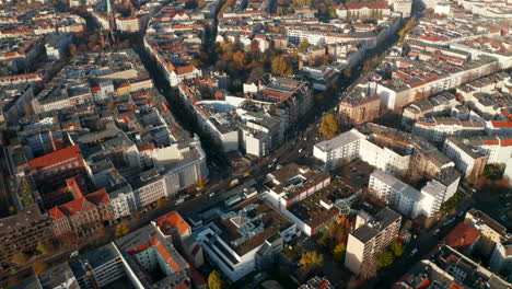 Typical-Berlin-Neighbourhood-residential-area-in-sunny-daylight-with-view-on-Red-rooftops-and-main-Street,-Aerial-Wide-Establishing-Shot