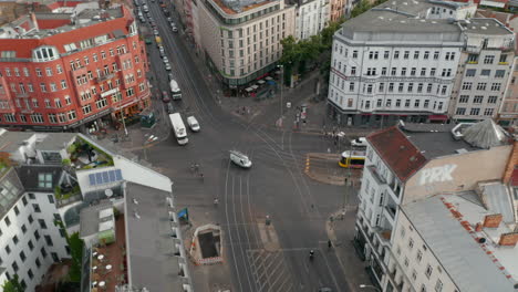 Rise-up-and-tilt-down-of-Rosenthaler-Platz.-Car-traffic-and-tram-driving-through-famous-square-in-centre-city.-Berlin,-Germany.