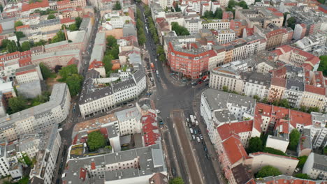 Aerial-view-of-cars-driving-through-Rosenthaler-Platz.-Flying-around-square-in-urban-neighbourhood.-Berlin,-Germany.
