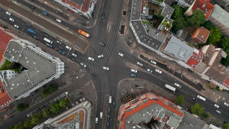 Aerial-birds-eye-overhead-top-down-view-of-cars-driving-through-intersection-on-Rosenthaler-Platz.--Traffic-in-city-centre.-Berlin,-Germany.