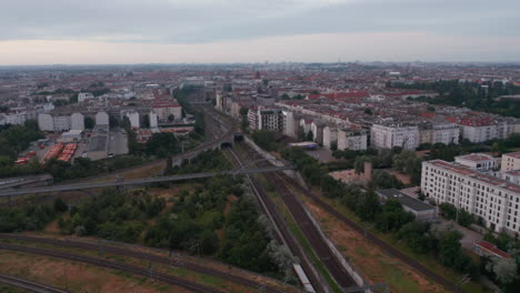 Aerial-view-of-railway-track-junction-surrounded-by-urban-neighbourhood-in-large-city.-Berlin,-Germany