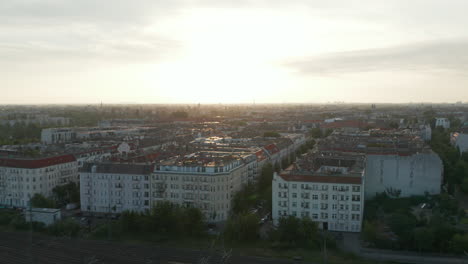 Aerial-view-of-blocks-of-apartment-buildings-in-urban-neighbourhood.-Morning-footage-against-bright-sky.-Berlin,-Germany