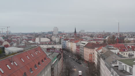 AERIAL:-Slow-flight-through-Empty-Central-Berlin-Neighbourhood-Street-Torstrasse-over-Rooftops-during-Coronavirus-COVID-19-on-Overcast-Cloudy-Day