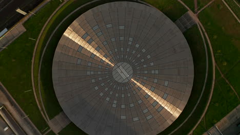 Aerial-Birds-Eye-Overhead-Top-Down-View-of-Velodrome-Arena-in-Berlin,-Germany.-Futuristic-Building-Architecture-with-Sunset-reflection