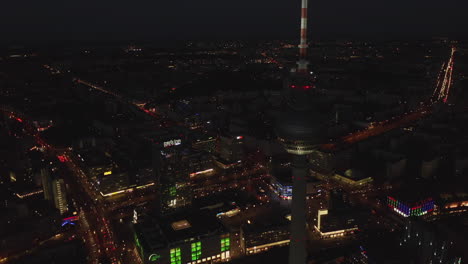 High-Angle-Establishing-Shot-of-Berlin-City-Center-at-Night-in-Germany-Capital-City-with-glowing-lights,-Aerial-Drone-Shot-in-2019
