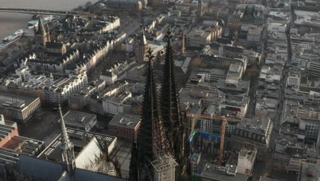 High-angle-view-of-top-of-two-richly-decorated-gothic-towers-of-Cathedral-Church-of-Saint-Peter-high-above-city.-Cologne,-Germany