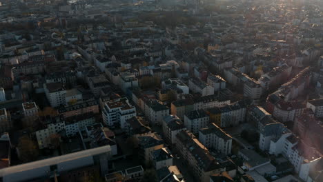 Aerial-view-of-buildings-and-streets-of-Bornheim-neighbourhood.-Tilt-up-revealing-skyline-with-group-of-skyscrapers-downtown.-Frankfurt-am-Main,-Germany