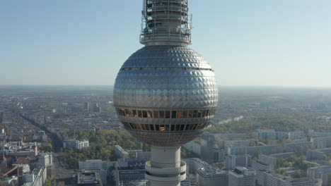 AERIAL:-Wide-View-of-the-top-of-Alexanderplatz-TV-Tower-with-Empty-Berlin,-Germany-Streets-in-background-on-hot-summer-day-during-COVID-19-Coronavirus-Pandemic