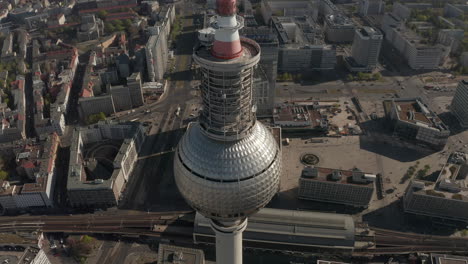 AERIAL:-Wide-View-of-the-top-of-Alexander-Platz-TV-Tower-with-Empty-Berlin,-Germany-Streets-in-background-on-hot-summer-day-during-COVID-19-Corona-Virus-Pandemic