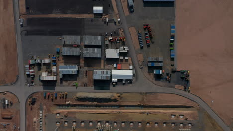 Equipment-at-construction-building-site-for-a-factory-in-Germany,-Aerial-Top-View