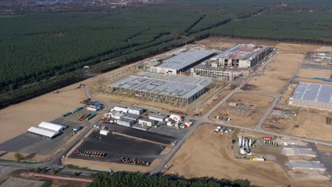 Hyper-Lapse-of-the-Tesla-Gigafactory-being-built-near-Berlin-Brandenburg,-Germany,-construction-site,-Aerial-Establishing-Shot,-Time-Lapse