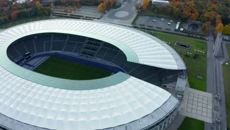 Olympiastadion-in-Berlin,-Germany-with-no-people-during-Coronavirus-Covid-19-Pandemic,-Aerial-Wide-Shot-Dolly-slide-right-establishing-shot,-October-2020