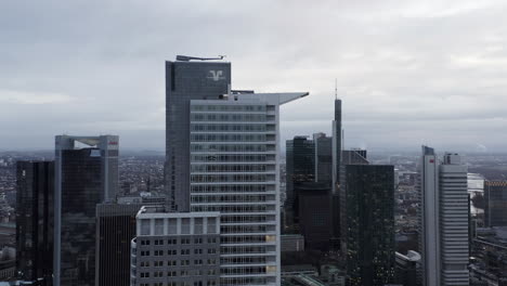 Top-of-DZ-Bank-skyscraper.-Modern-design-tall-office-building-in-financial-borough.-Windows-reflecting-city-bellow.-Frankfurt-am-Main,-Germany