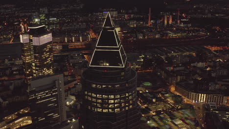 AERIAL:-Messeturm-in-Frankfurt-am-Main,-Germany-at-Night,-Big-City,-Lights,-Skyscraper