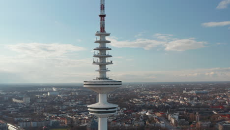 Close-up-aerial-view-of-Heinrich-Hertz-TV-tower-rising-above-cityscape-in-Hamburg-city-center