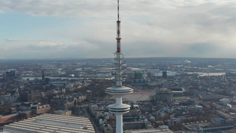 Aerial-dolly-out-view-of-tall-white-Heinrich-Hertz-TV-tower-rising-above-Hamburg-cityscape