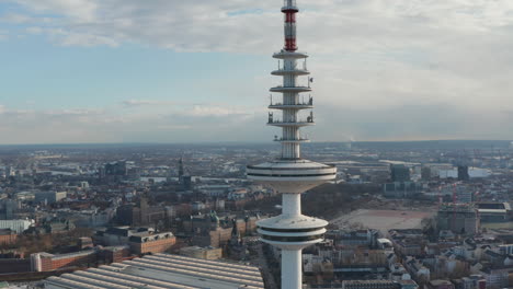 Close-up-aerial-view-of-observation-deck-on-top-of-Heinrich-Hertz-TV-tower-rising-above-Hamburg-cityscape