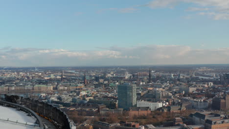 Aerial-reveal-of-Hamburg-city-center-with-famous-buildings-and-landmarks-behind-Heinrich-Hertz-TV-tower-observation-deck