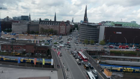 Aerial-view-of-traffic-in-town.-Busy-complex-multilane-intersection-located-at-railway-track.-Various-modes-of-transport-in-city.-Free-and-Hanseatic-City-of-Hamburg,-Germany