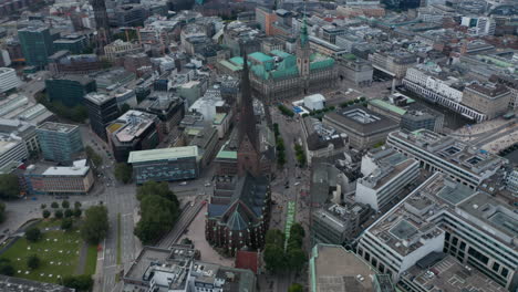 Slide-and-tilt-footage-of-historic-city-centre.-Aerial-view-of-landmarks,-churches-and-city-hall.--Free-and-Hanseatic-City-of-Hamburg,-Germany