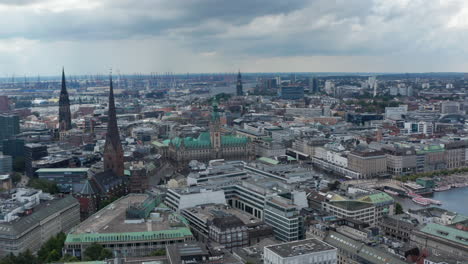 Orbit-shot-around-City-hall-building-with-tall-tower-and-green-roof.-Aerial-view-of-landmarks-in-Altstadt-district.-Free-and-Hanseatic-City-of-Hamburg,-Germany