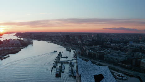Aerial-view-of-modern-buildings-in-Hamburg-city-center-on-the-banks-of-Elbe-river-during-sunset