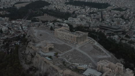 Aerial-Circling-Acropolis-of-Athens-after-Sunset-at-Dusk