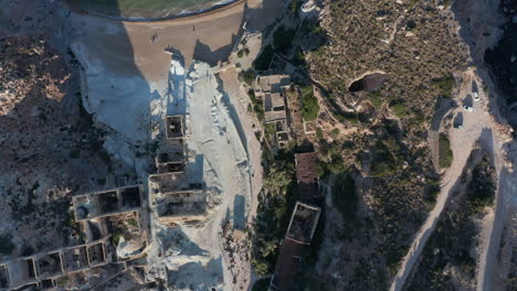 Aerial-Overhead-Top-Down-Birds-Eye-View-of-an-Abandoned-Factory-Village-at-Beach-on-Greek-Island