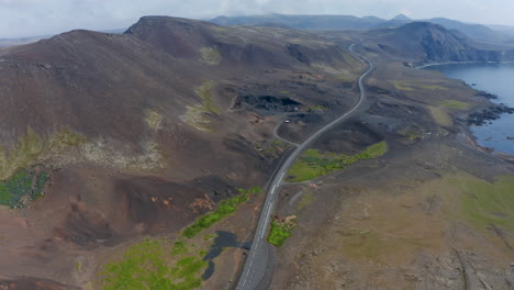 Overhead-drone-view-over-Ring-Road,-the-most-important-and-longest-highway-in-Iceland.-Look-up-aerial-view-revealing-the-beautiful-coastline-with-black-sand-beach