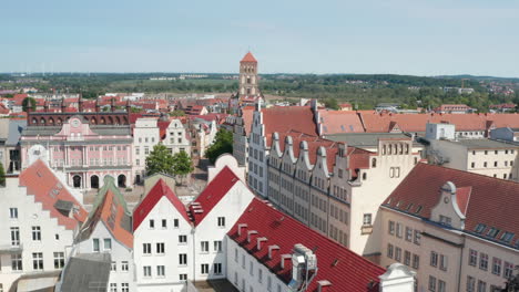 Forwards-fly-and-tilt-down-reveal-Neuer-Markt-square-with-colourful-gabled-houses-and-building-of-city-hall