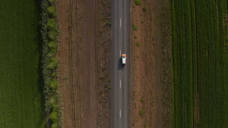 Top-down-drone-view-of-calm-and-peaceful-car-travelling-ring-road-exploring-iceland.-Overhead-aerial-view-off-road-car-discovering-icelandic-countryside