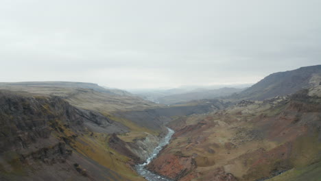 Aerial-drone-view-of-fossa-river-through-Haifoss-valley-with-green-moss-cliffs-in-Iceland.-Birds-eye-view-of-Fossa-river-gently-flowing-in-Landmannalaugar-canyon-valley