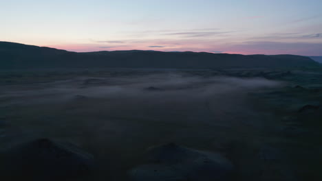 Drone-view-of-amazing-foggy-Iceland-countryside.-Birds-eye-of-icelandic-highlands-covered-with-mist-and-fog.-Solitude,-desolation,-loneliness.-Iceland-moonscape