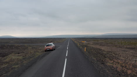 Drone-view-car-stopped-along-Ring-road,-national-road-that-runs-around-Iceland-and-connects-most-of-the-inhabited-parts-of-the-country.-Exploration-and-adventure.-Panorama-icelandic-countryside