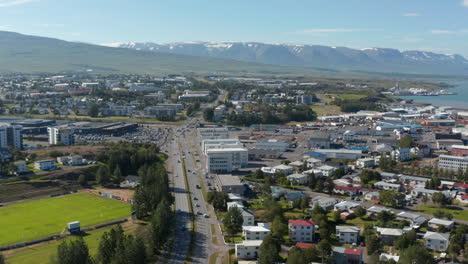 Aerial-view-of-busy-street-in-Reykjavik-city-centre,-Iceland-capital-city.-Birds-eye-over-Reykjavik-colorful-rooftop-coastline.-Travel-destination.-European-capital-city