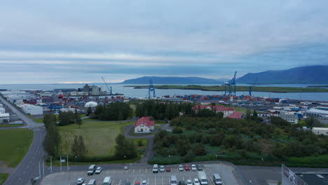 Birds-eye-view-of-the-largest-cargo-port-in-Iceland,-Sundahofn-in-Reykjavik,-icelandic-capital-city.-Aerial-view-of-containers-stocked-and-ready-to-be-shipped-in-coastal-harbor.-Trading-concept