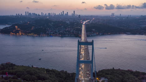 Istanbul-Bosphorus-Bridge-at-Sunset-with-Car-traffic-lights-and-City-Skyline,-Aerial-Hyperlapse-Motion-Time-Lapse-slide