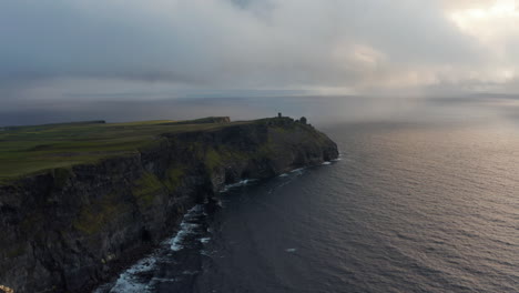 Aerial-panoramic-footage-of-sea-coast-with-high-cliffs.-Waves-rolling-to-shore.-Cliffs-of-Moher,-Ireland