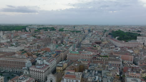 Aerial-panoramic-footage-of-buildings-and-streets-in-city-centre.-Large-historic-palaces-at-twilight.-Rome,-Italy