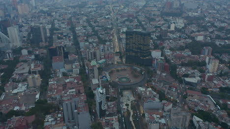 Aerial-drone-view-of-cityscape-with-large-roundabout-crossing.-Camera-tilting-down.-Mexico-city,-Mexico.